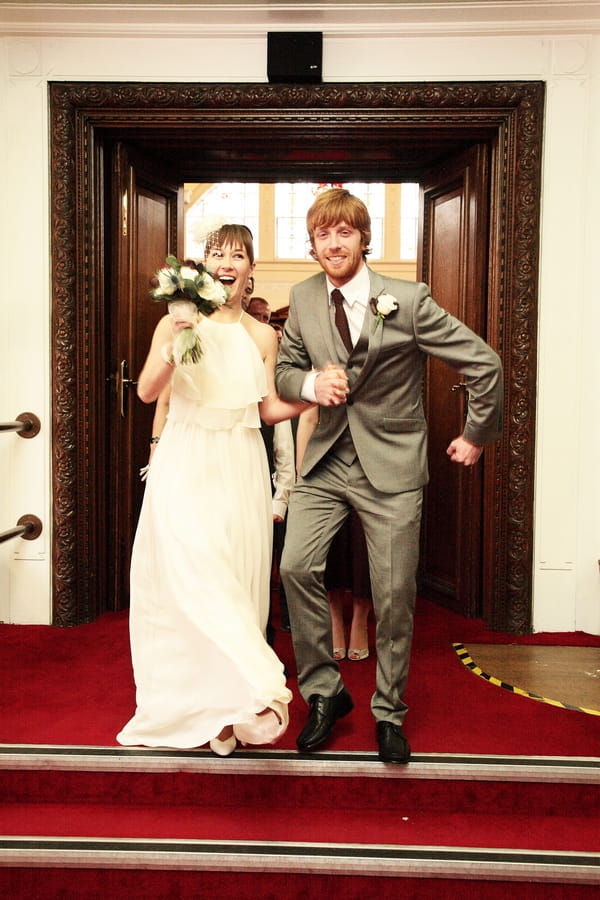 Groom doing funny jig after leaving wedding ceremony - Picture by Rebecca Prigmore Photography