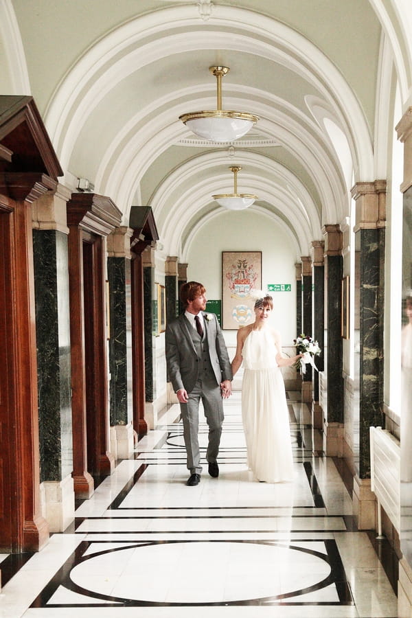 Bride and groom walking down corridor - Picture by Rebecca Prigmore Photography