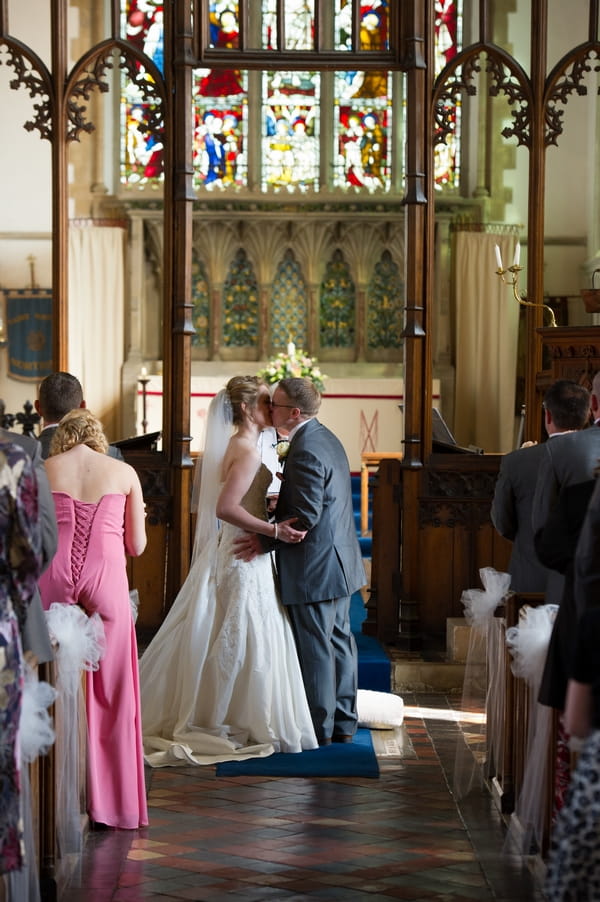 Bride and groom kiss at altar - Picture by Gareth Squance Photography