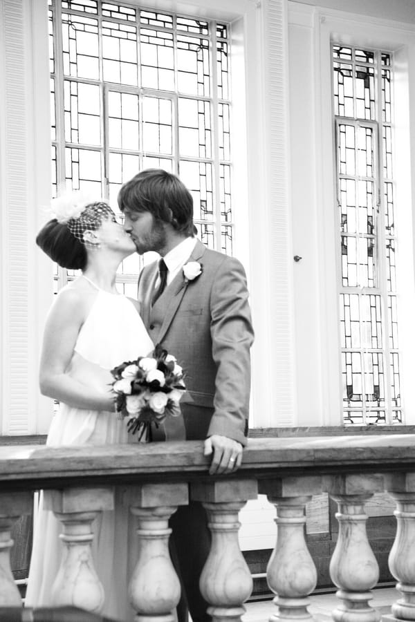 Bride and groom kiss on balcony - Picture by Rebecca Prigmore Photography