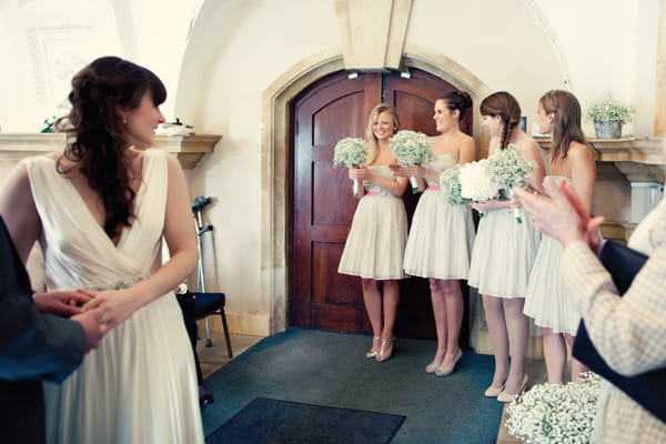 Bride turning to look at bridesmaids - A Homemade Marquee Wedding
