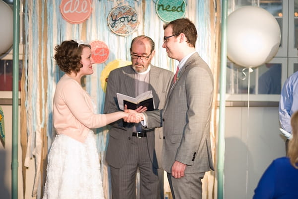 Bride and groom holding hands during wedding ceremony - A Fun, Fun, Fun Wedding