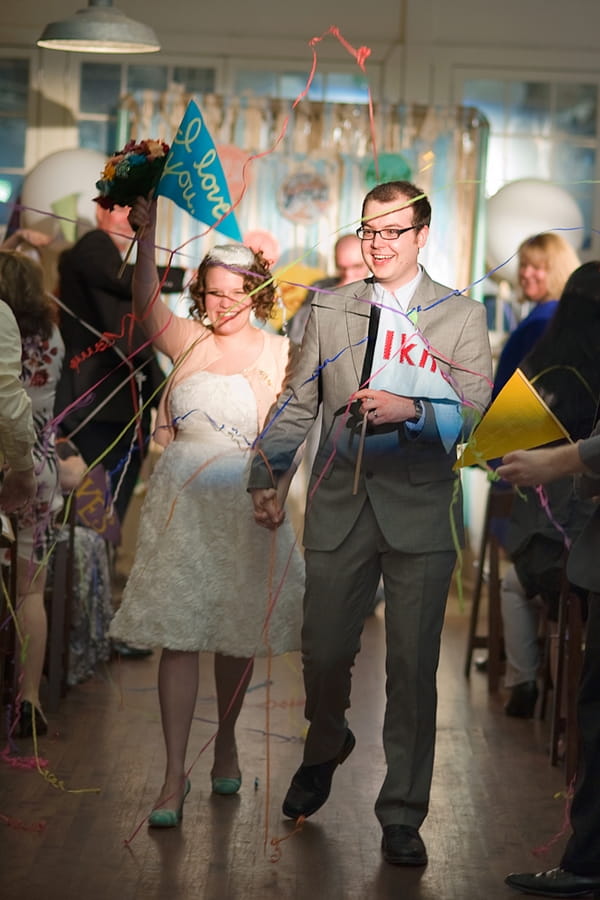 Bride and groom leaving wedding ceremony hand in hand - A Fun, Fun, Fun Wedding