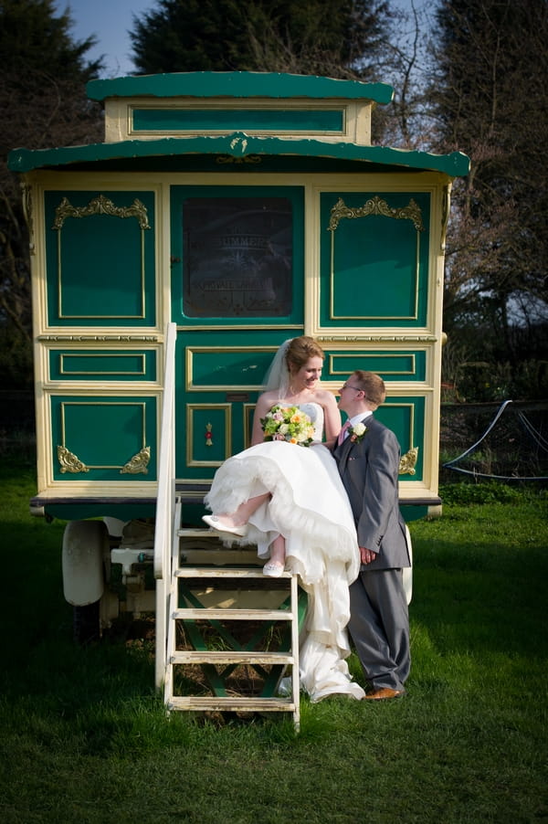 Bride and groom by small green caravan - Picture by Gareth Squance Photography