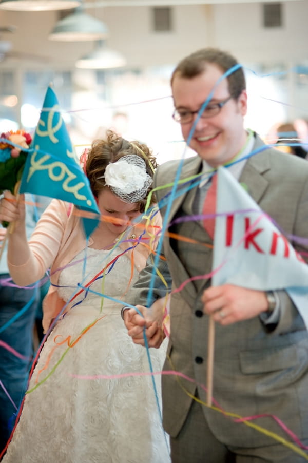 Bride and groom walking through streamers - A Fun, Fun, Fun Wedding