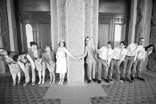 Bride and groom holding hands with bridal party by their side - A Fun, Fun, Fun Wedding