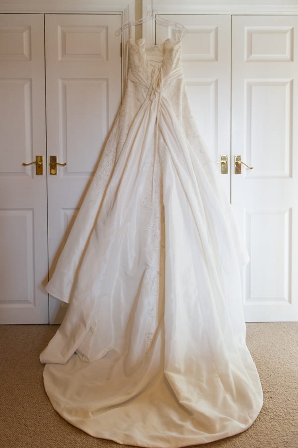 Wedding dress hanging over wardrobe - Picture by Gareth Squance Photography