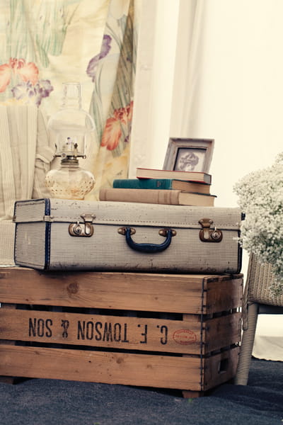 Suitcase and books on crate as wedding decoration - A Homemade Marquee Wedding