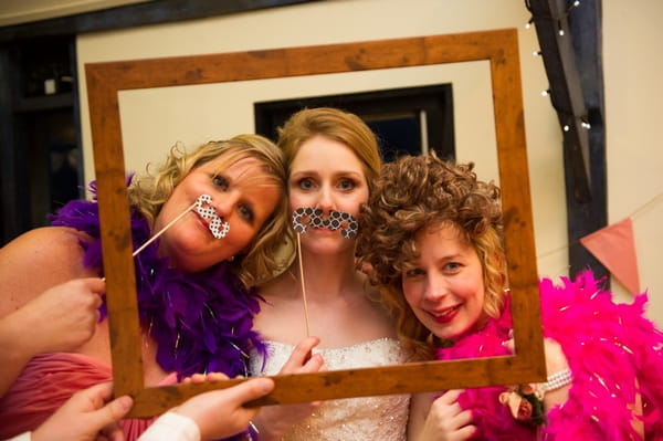 Bride and bridesmaids posing with props - Picture by Gareth Squance Photography