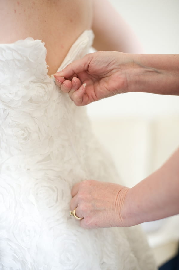 Back of wedding dress being done up - A Fun, Fun, Fun Wedding