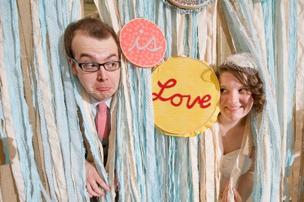 Bride and groom's heads through streamers - A Fun, Fun, Fun Wedding