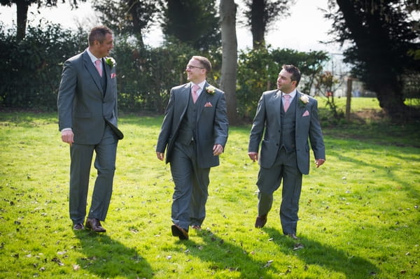 Groomsmen walking across grass - Picture by Gareth Squance Photography