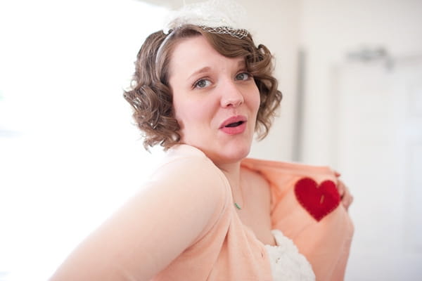 Bride showing heart on pink cardigan - A Fun, Fun, Fun Wedding