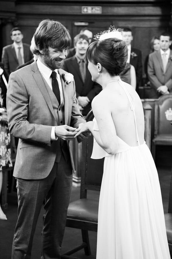 Groom placing ring on bride's finger - Picture by Rebecca Prigmore Photography