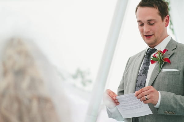 Man looking down at his wedding speech - Picture by McKinley Rodgers Photography