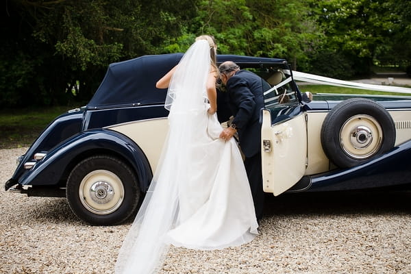 Bride getting into wedding car - A Beautiful Garden Party Wedding at Lains Barn