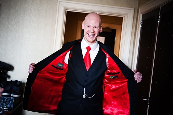 Groom wearing jacket with red lining - An Art Deco Themed Civil Partnership