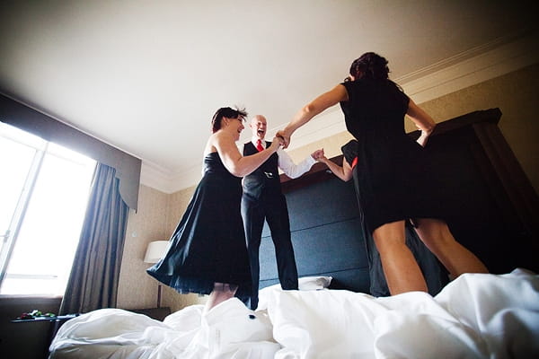 Groom and bridesmaids jumping on bed - An Art Deco Themed Civil Partnership