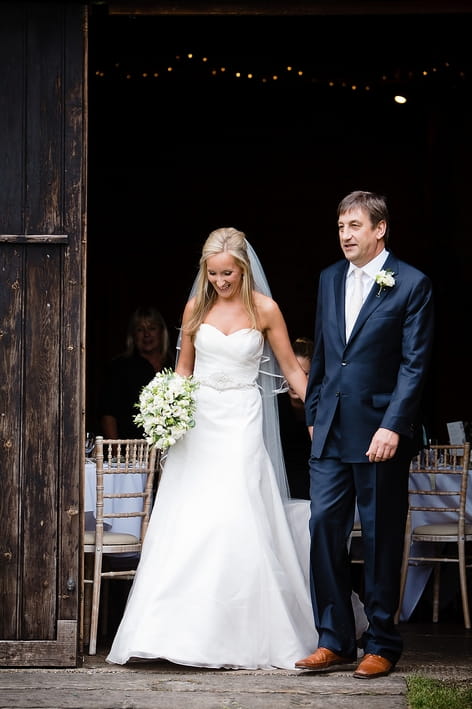 Bride and father leave wedding barn - A Beautiful Garden Party Wedding at Lains Barn