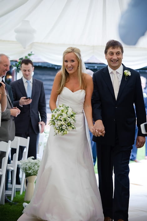 Bride walking down aisle with father - A Beautiful Garden Party Wedding at Lains Barn