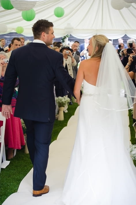 Bride and groom walking down aisle - A Beautiful Garden Party Wedding at Lains Barn