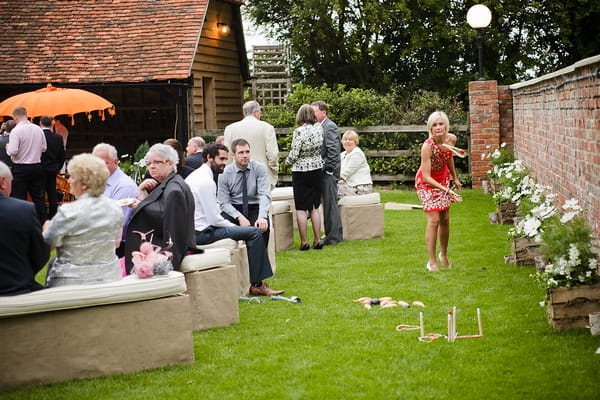 Wedding guests playing lawn games - A Beautiful Garden Party Wedding at Lains Barn