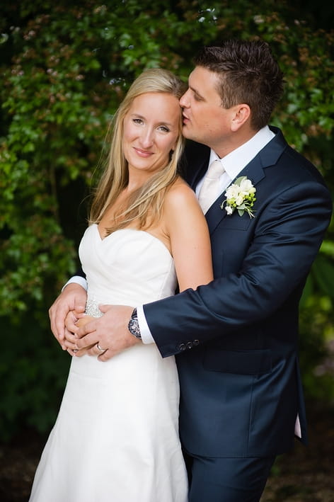 Groom kissing bride on head - A Beautiful Garden Party Wedding at Lains Barn