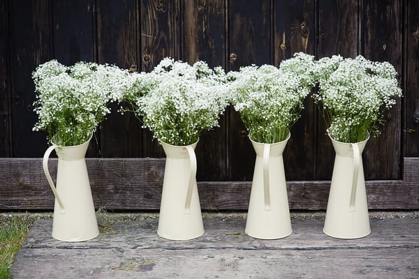 Wedding flowers in jugs - A Beautiful Garden Party Wedding at Lains Barn