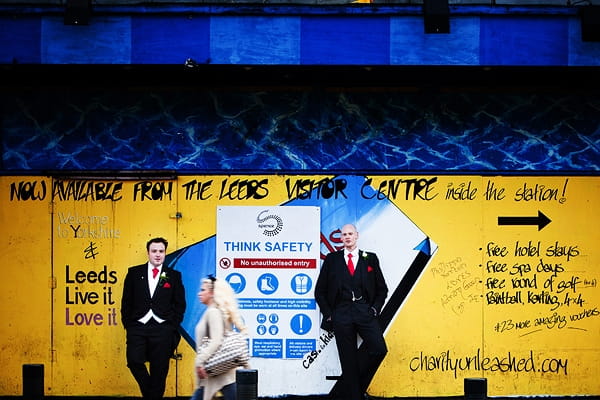 Civil partners standing by yellow wall - An Art Deco Themed Civil Partnership