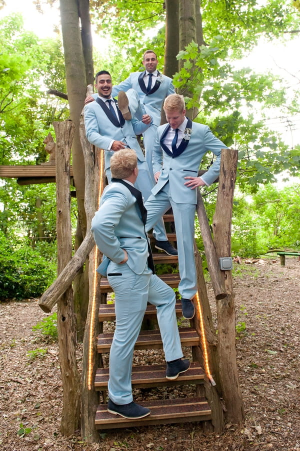 Groomsmen standing on wooden steps - A Wedstock Wedding in Hertfordshire