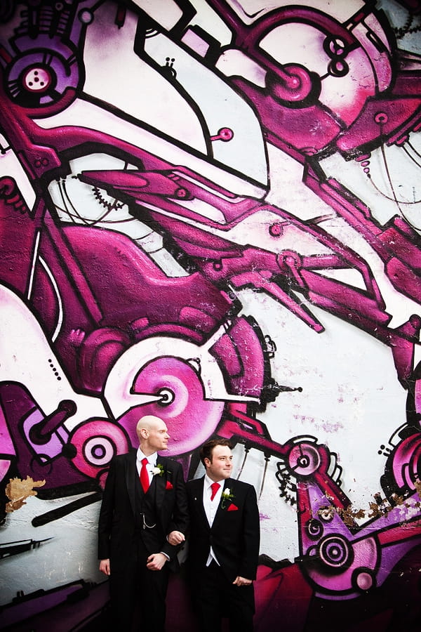 Civil partners standing by incredible purple wall art - An Art Deco Themed Civil Partnership