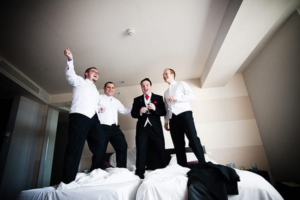 Groom and groomsmen jumping on bed - An Art Deco Themed Civil Partnership