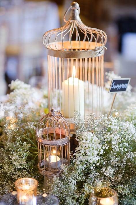 Candles in bridcage lanterns - A Beautiful Garden Party Wedding at Lains Barn