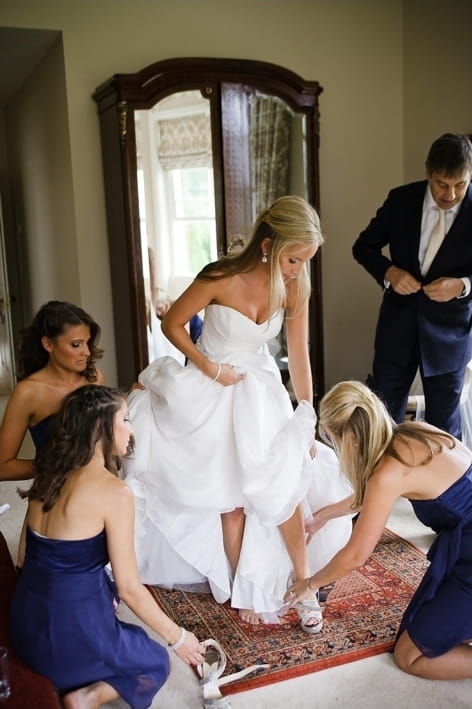 Bridesmiads helping bride with shoes - A Beautiful Garden Party Wedding at Lains Barn