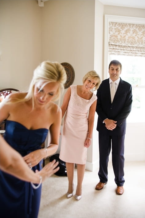 Brides mother nad father watching bride get ready - A Beautiful Garden Party Wedding at Lains Barn