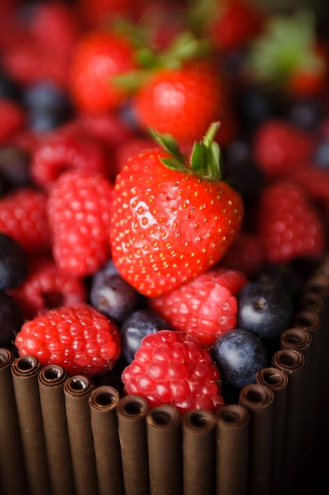 Strawberries on wedding cake - A Beautiful Garden Party Wedding at Lains Barn