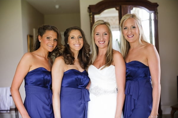 Bride with bridesmaids in blue dresses - A Beautiful Garden Party Wedding at Lains Barn