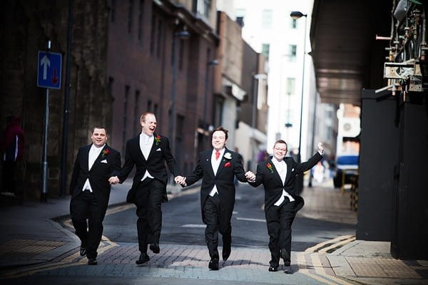 Groom and groomsmen skipping down road - An Art Deco Themed Civil Partnership