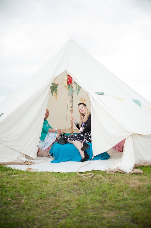 Wedding guests in small tepee - A Wedstock Wedding in Hertfordshire