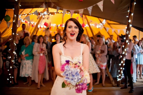 Bride about to throw bouquet - A Wedstock Wedding in Hertfordshire