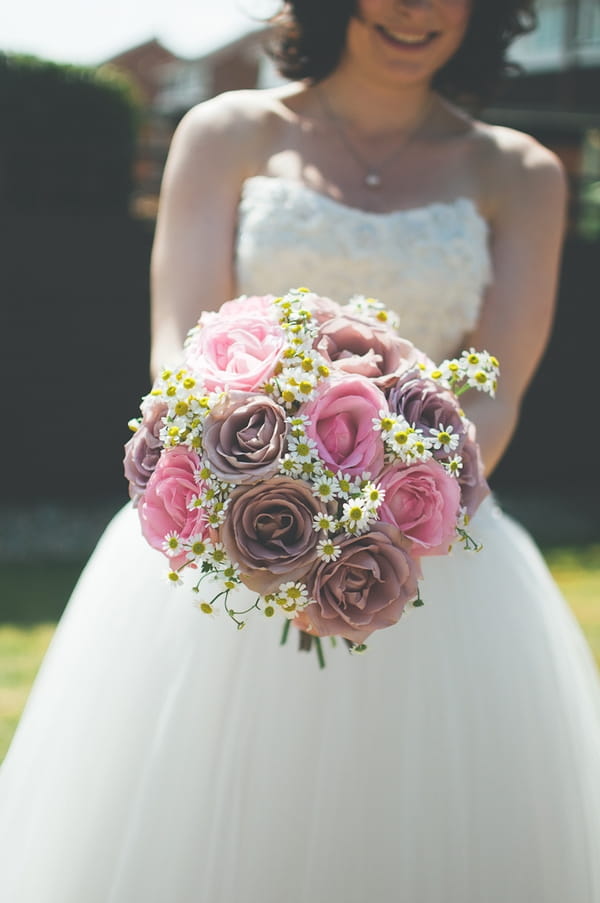 Bride holding rose bouquet - A Farm Wedding with a British Summer Theme