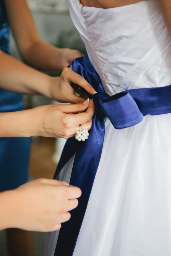 Blue ribbon on wedding dress - A Spring Themed Wedding in Hungary