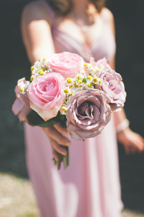 Bridesmaid holding rose bouquet - A Farm Wedding with a British Summer Theme