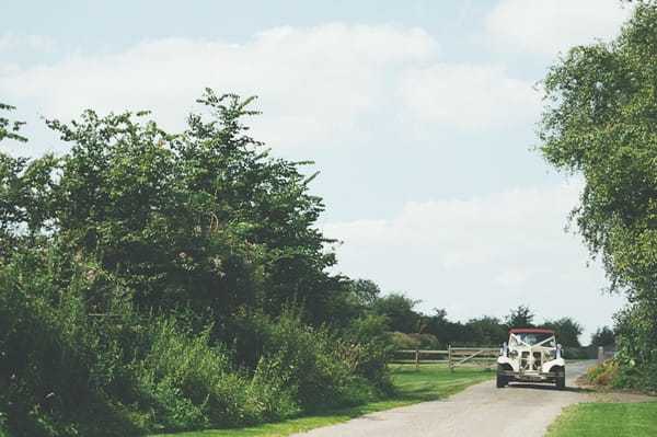 Wedding car driving down country lane - A Farm Wedding with a British Summer Theme