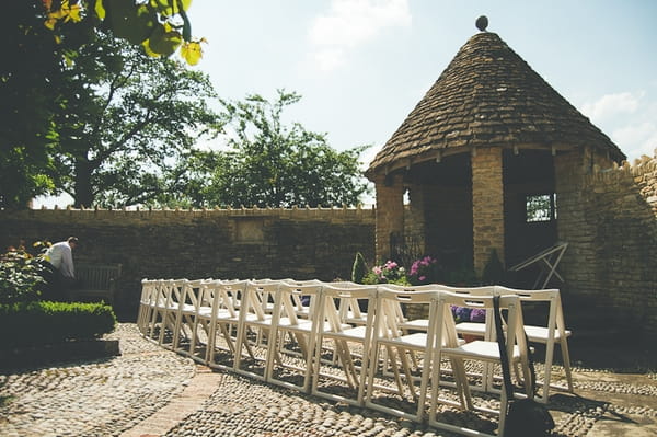 Chairs lined up for wedding ceremony outside - A Farm Wedding with a British Summer Theme