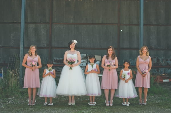 Bride and bridesmaids standing in a line - A Farm Wedding with a British Summer Theme