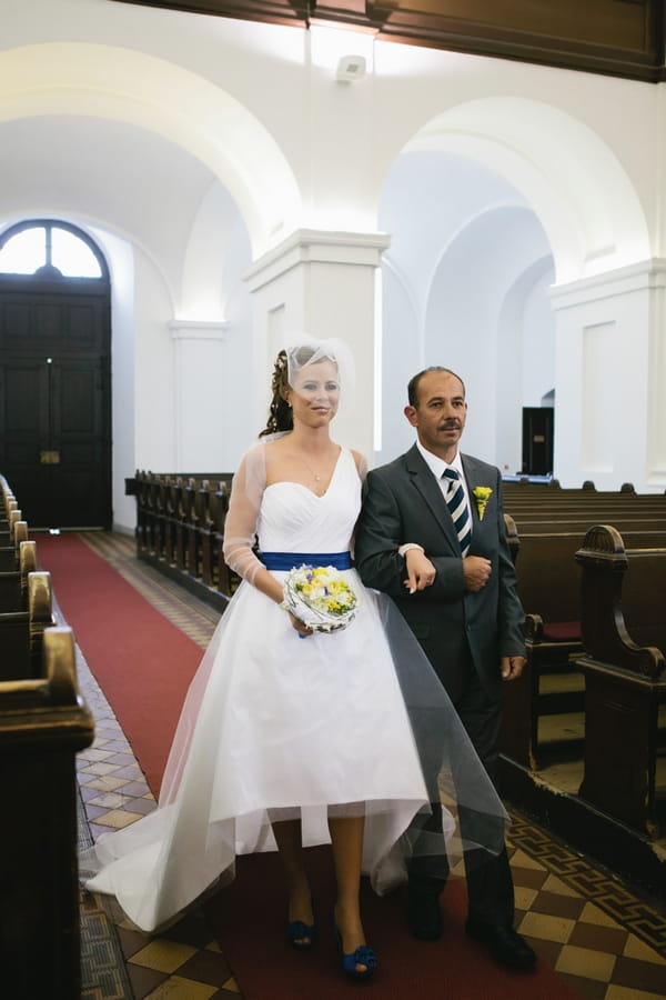 Bride and father walk into church - A Spring Themed Wedding in Hungary