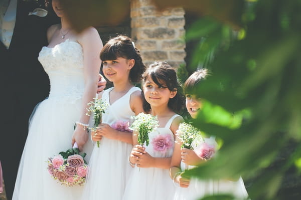 Flower girls holding bouquets - A Farm Wedding with a British Summer Theme