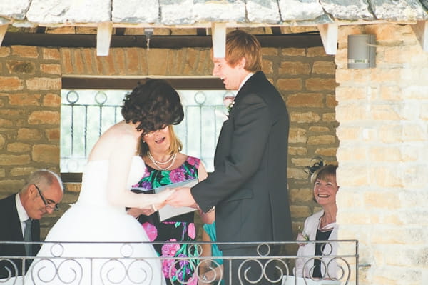 Bride and groom laughing during wedding ceremony - A Farm Wedding with a British Summer Theme