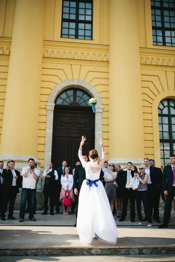 Bride throwing bouquet - A Spring Themed Wedding in Hungary